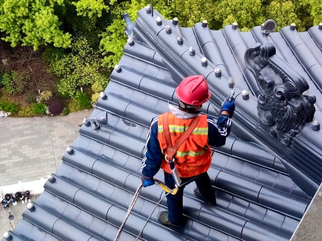 commercial roofing crew working with safety equipment - commercial roofers near me